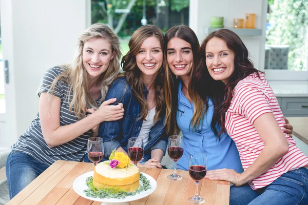 Women with birthday cake and glasses of red — Stock Photo, Image