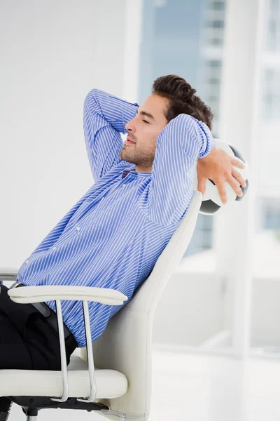 Businessman holding a football — Stock Photo, Image