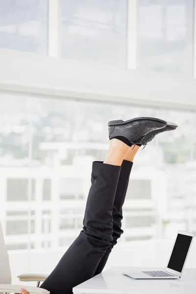 Businessman lying on ground with feet up — Stock Photo, Image