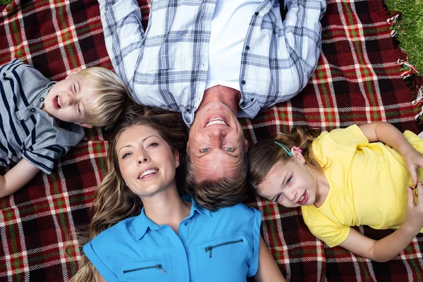 Family lying together in park — Stock Photo, Image