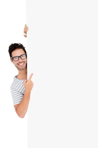 Man hiding behind white board — Stock Photo, Image