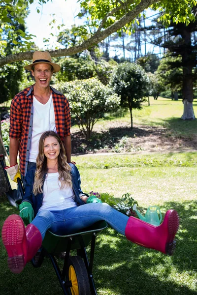 Couple playing with wheelbarrow — Stock Photo, Image