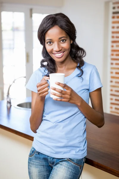 Mulher segurando caneca de café sorrindo — Fotografia de Stock