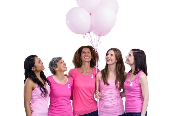 Women in pink outfits posing with balloons — Stock Photo, Image