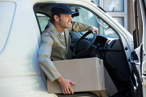 Delivery man getting out from — Stock Photo, Image