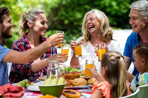 Familie roosteren drankjes in gazon — Stockfoto