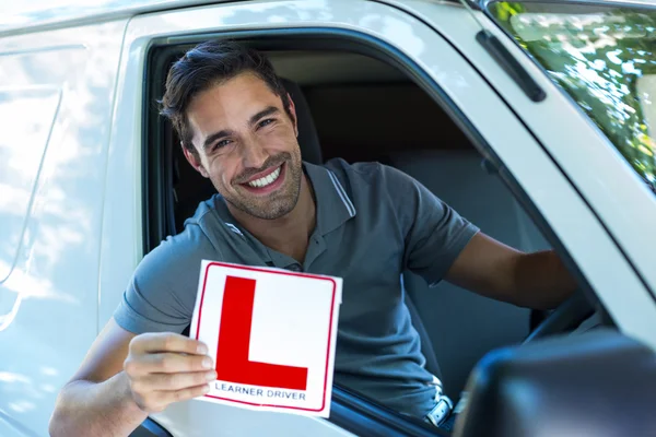 Man with leaning sign — Stock Photo, Image