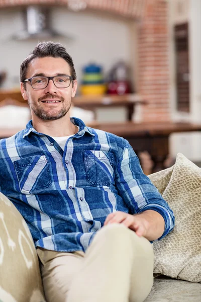 Man sitting on sofa — Stock Photo, Image