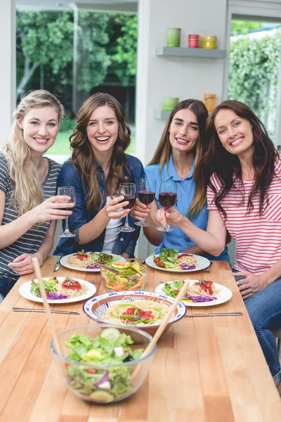 Friends holding glasses of red wine — Stock Photo, Image