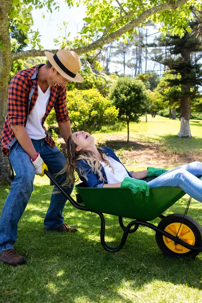 Couple playing with wheelbarrow — Stock Photo, Image