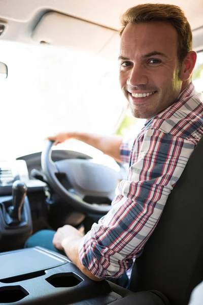 Man sitting on cars front seat — Stock Photo, Image