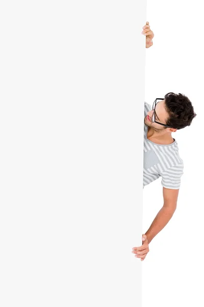 Man hiding behind white board — Stock Photo, Image