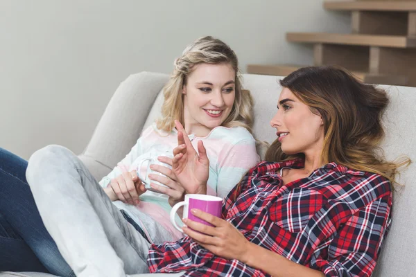 Women holding cups of coffee — Stock Photo, Image