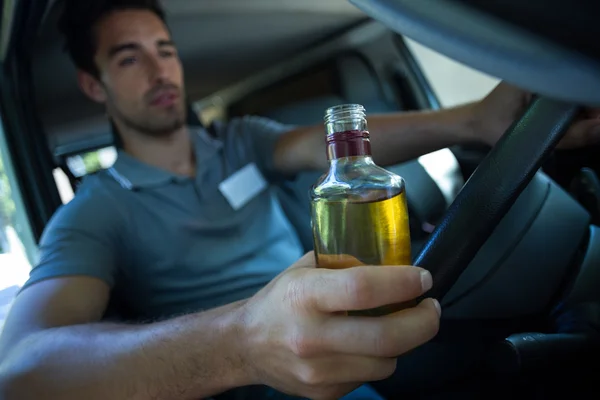 Slumped man holding alcohol — Stock Photo, Image