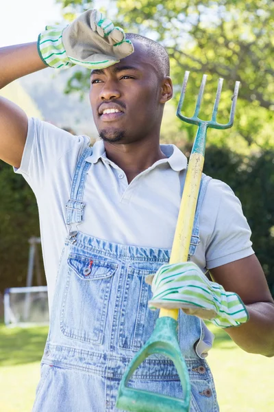 Young man posing with rake — Stock Photo, Image