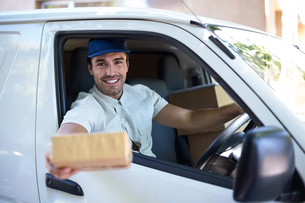 Delivery man giving cardboard box — Stock Photo, Image