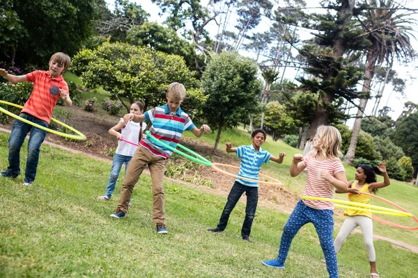 Children playing with hula hoops — Stock Photo, Image