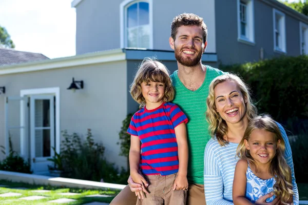 Cheerful family against house — Stock Photo, Image