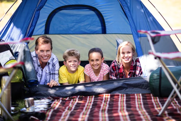 Happy family lying in tent — Stock Photo, Image