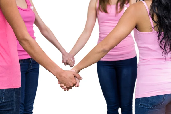 Women in pink outfits joining in circle — Stock Photo, Image