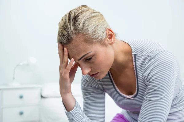 Upset woman with headache at home — Stok fotoğraf