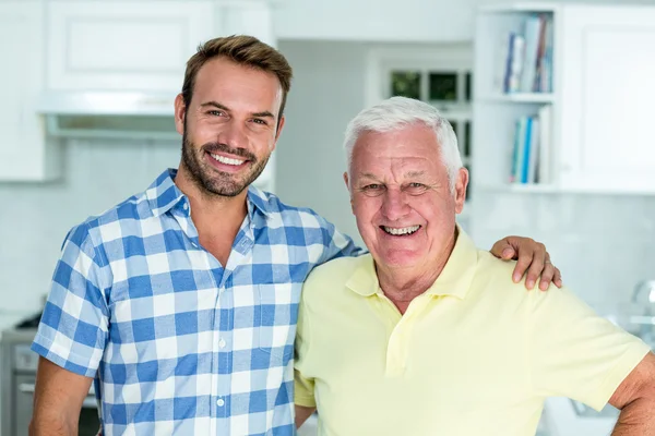 Man standing with father at home — Stock Photo, Image
