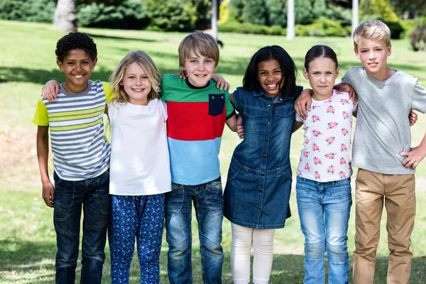 Portrait of happy children standing together in park — Stock Photo, Image