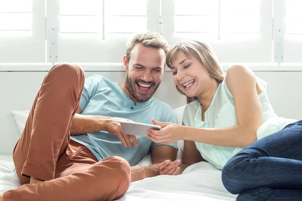 Couple using mobile phone on bed — Stock Photo, Image