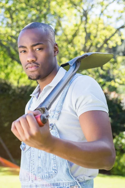 Young man posing with shovel — Stock Photo, Image