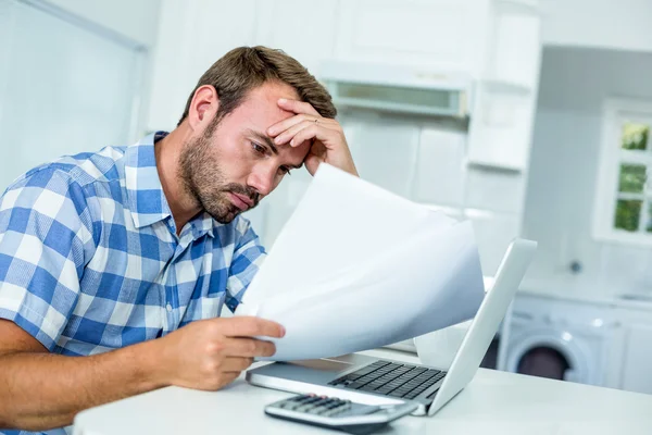 Tensed man looking in documents — Stock Photo, Image