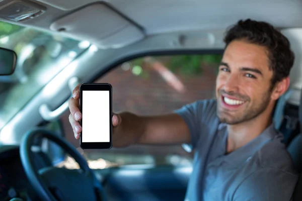 Man holding phone in car — Stock Photo, Image