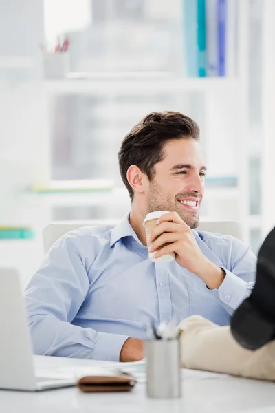 Mann sitzt mit Füßen auf Tisch — Stockfoto