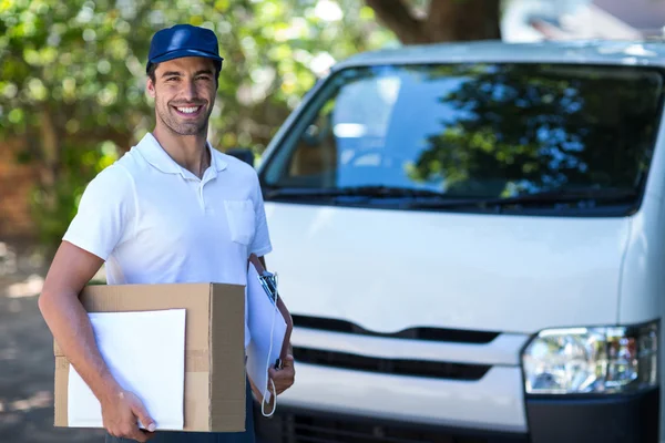 Delivery person with cardboard box — Stock Photo, Image