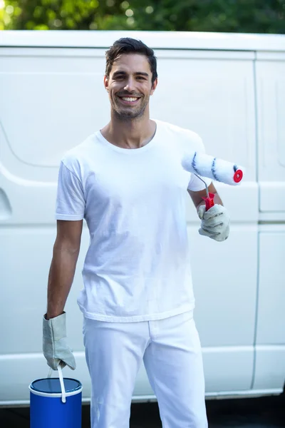 Painter with equipment standing against van — Stock Photo, Image