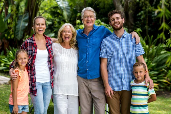 Multi generation family standing in yard — Stock Photo, Image