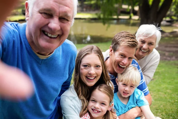 Family posing for selfie in park — Stock Photo, Image
