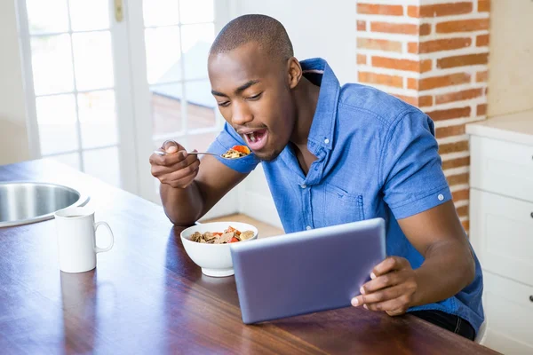 Mann frühstückt mit Tablet — Stockfoto