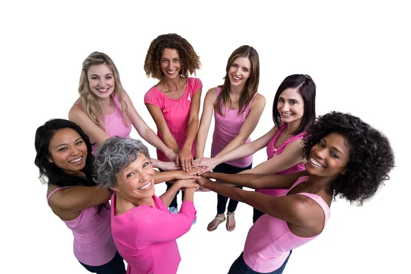 Women in pink outfits joining in circle — Stock Photo, Image