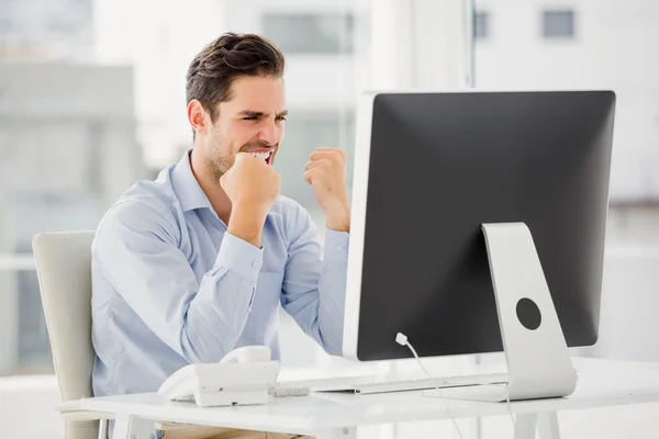 Businessman cheering in his office — Stock Photo, Image