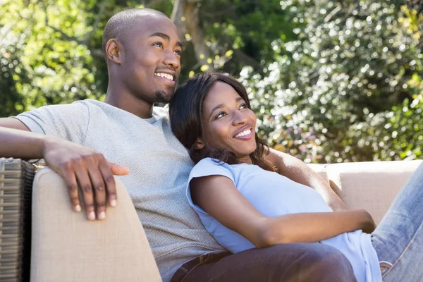 Young couple relaxing on sofa Stock Picture