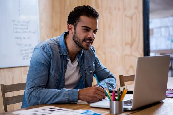 Man writing note on diary — Stock Photo, Image