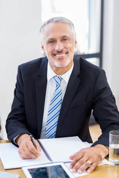 Businessman is sitting in front of office — Stock Photo, Image