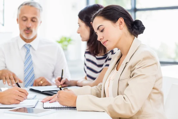 Business woman is taking some notes — стоковое фото