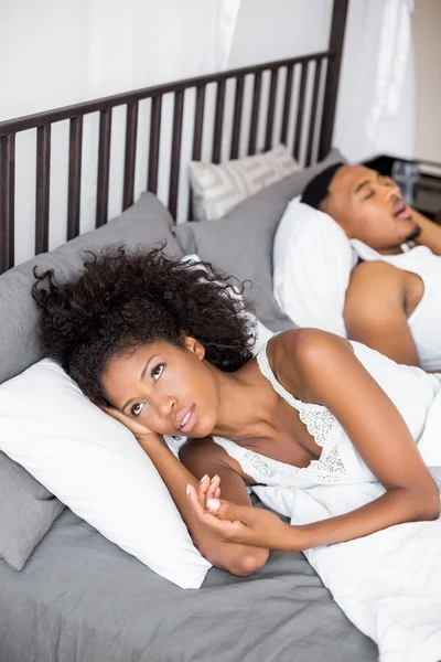 Thoughtful woman lying in her bed — Stock Photo, Image