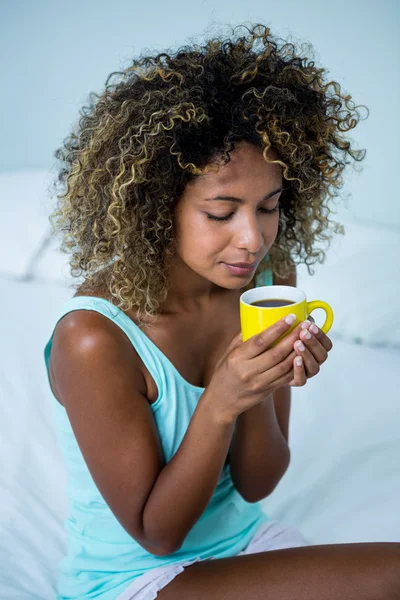 Kobieta pije kawę na łóżku — Zdjęcie stockowe