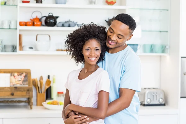 Junges Paar umarmt sich in der Küche — Stockfoto
