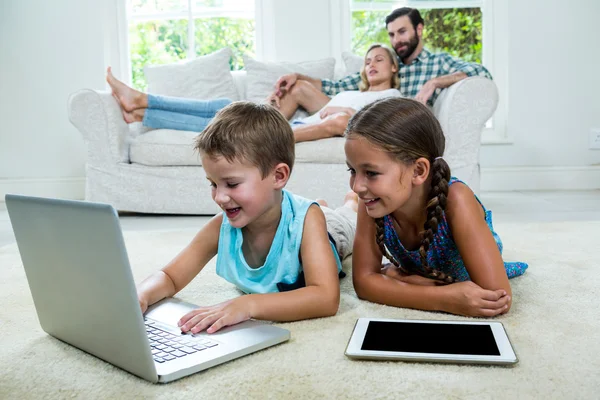 Niños usando el ordenador portátil en casa — Foto de Stock