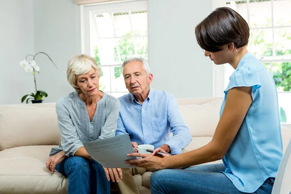 Female consultant showing report to couple — Stock Photo, Image