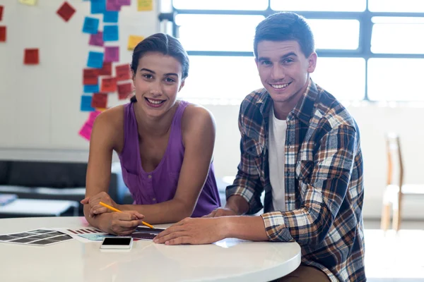 Colleagues sitting at their desk — Stock Photo, Image