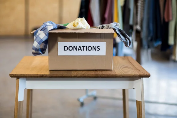 Donation box on a wooden table — Stock Photo, Image